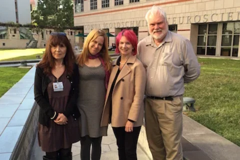 Four scientists in the Crosbie-Watson lab stand outside smiling, celebrating the important milestone of sarcospan in healing the dystrophic heart.