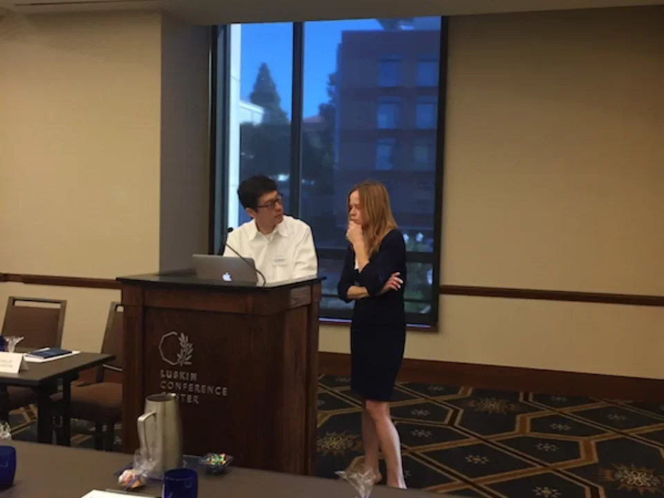 Two people standing at podium of 2016 CDMD Retreat