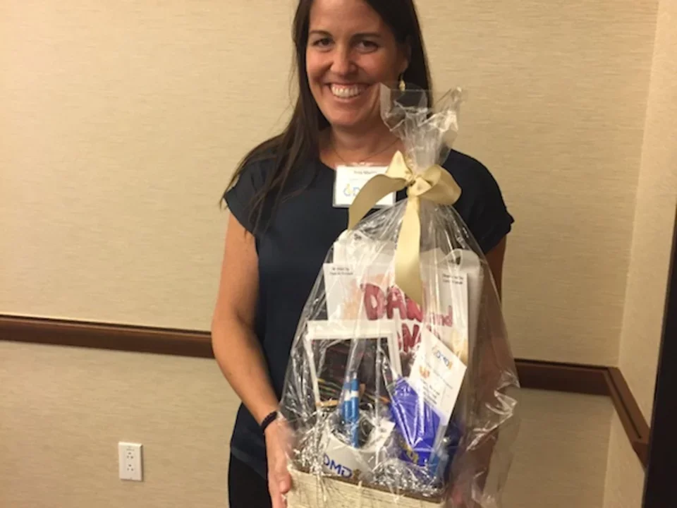 Woman holding gift basket at 2016 CDMD Retreat