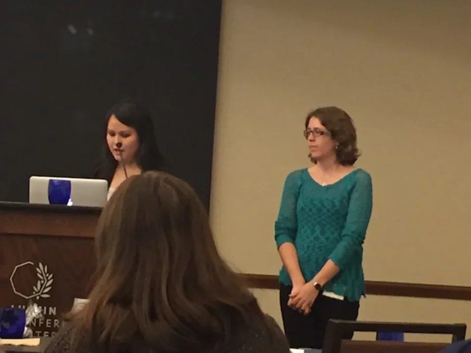 Two women presenting in front of podium at 2016 CDMD Retreat